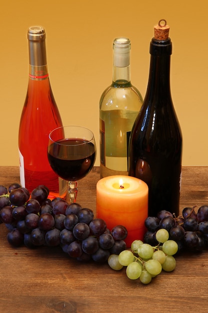 wine bottle and grapes on wood