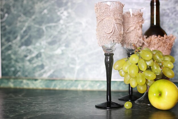 Premium Photo | Wine bottle green grape on background