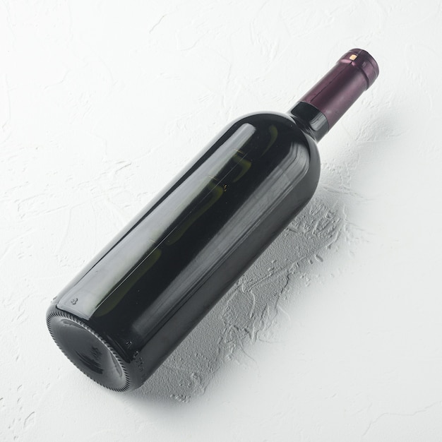 Wine bottle set, square format, on white stone table