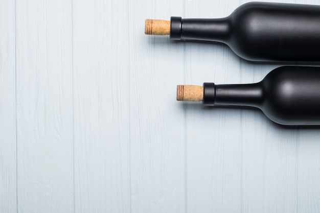 Wine bottle on white wooden background.