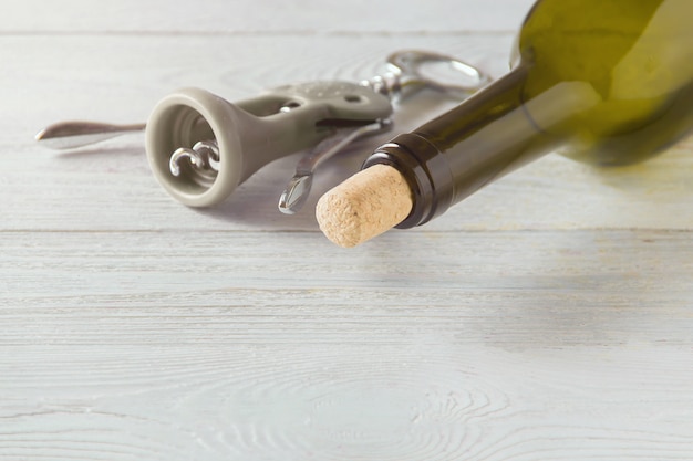 Wine bottle on white wooden table 