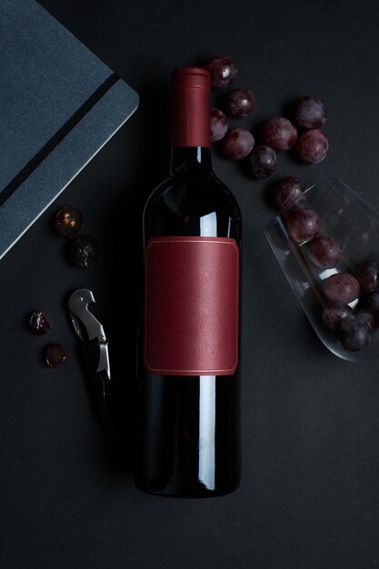 Wine bottle with glass grapes bottle opener and notebook