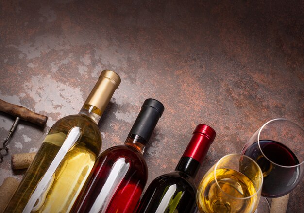 Wine bottles, glass and corks on table