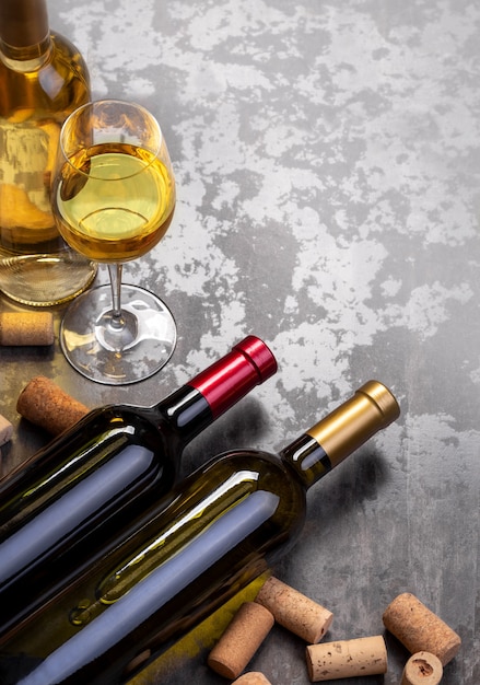 Wine bottles and glass on table with copy space, background