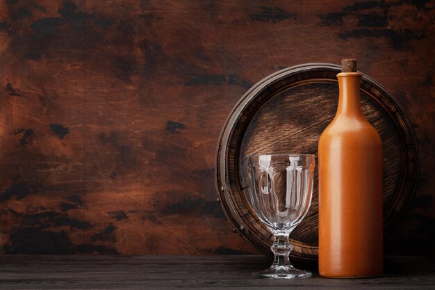 Wine bottles and old wooden barrel