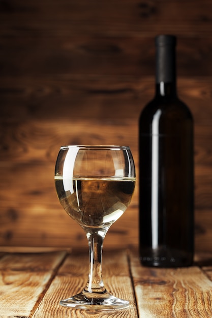 Wine bottles with glass, wooden 