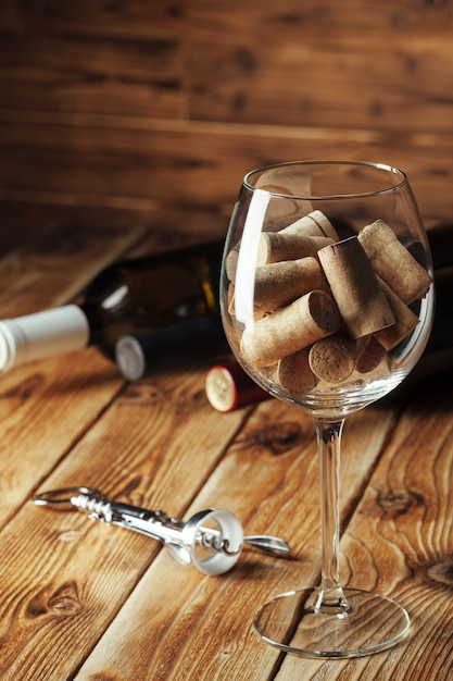 Wine bottles with glass, wooden