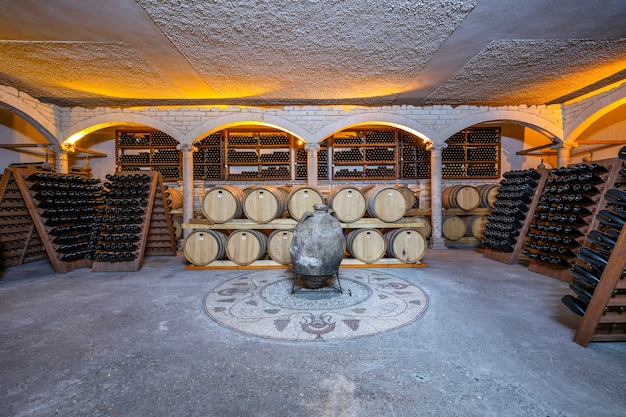 Wine cellar with barrels and bottles