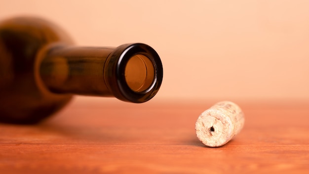 Wine cork and lying empty  bottle  on the table.