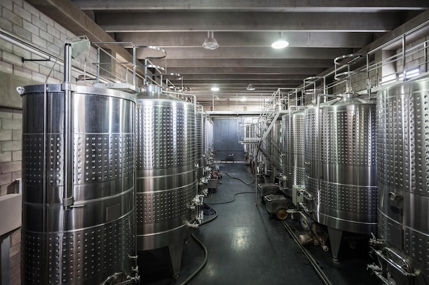 Wine Fermenting process in stainless steel vats in a wine cellar