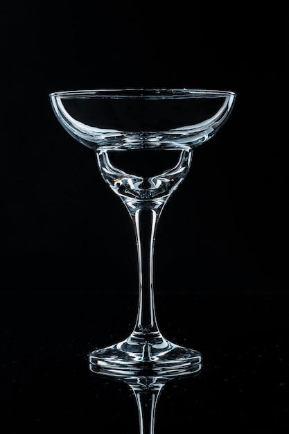 Wine glass on black background, front view