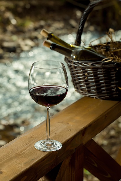 Wine glass and bottles in basket