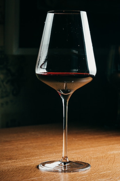 Wine glass in entertaining room among sunset window background