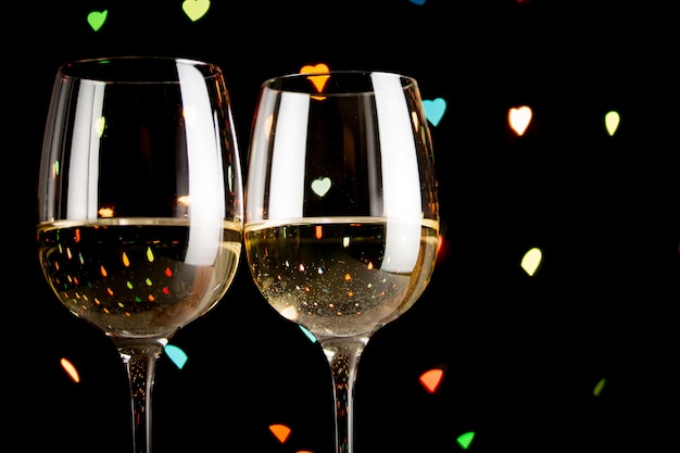 Wine glass on hearts bokeh