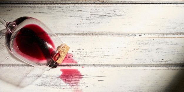 Wine glass lying on vintage wooden table