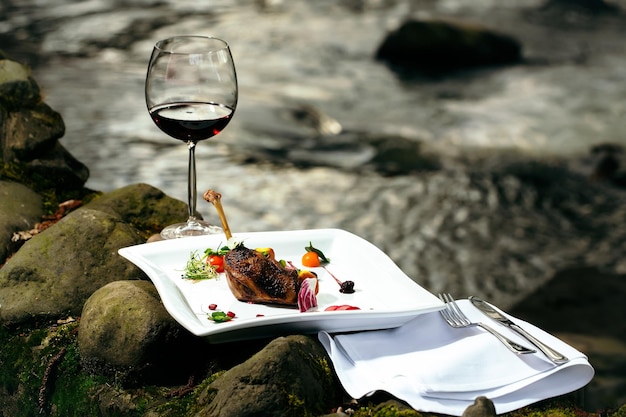 Wine glass and meal near water