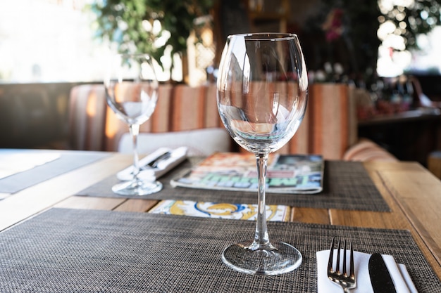 Wine glass in a restaurant. A table in the restaurant for guests.