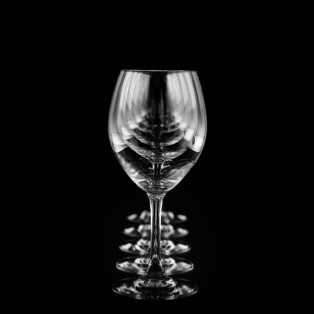 Wine glasses on black background with infinity effect