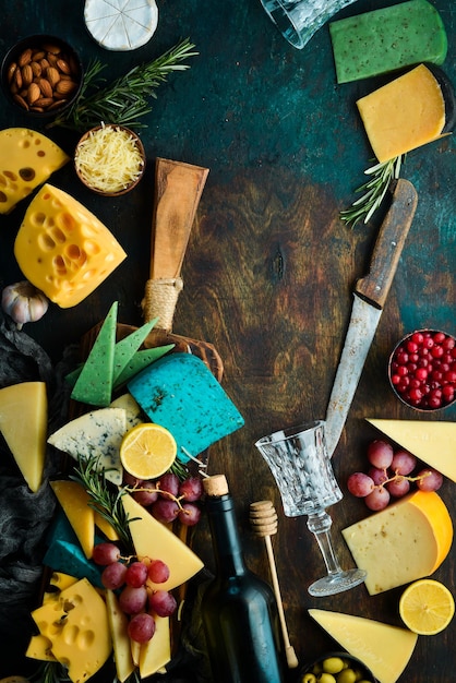 Wine glasses and cheese with snacks On a dark background Free copy space