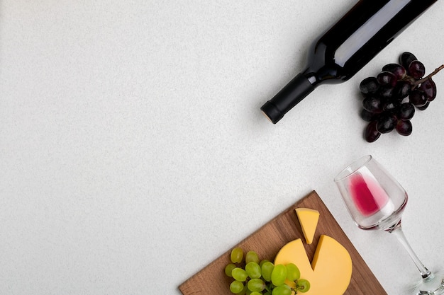 Wine glasses and corkscrew over white background top view