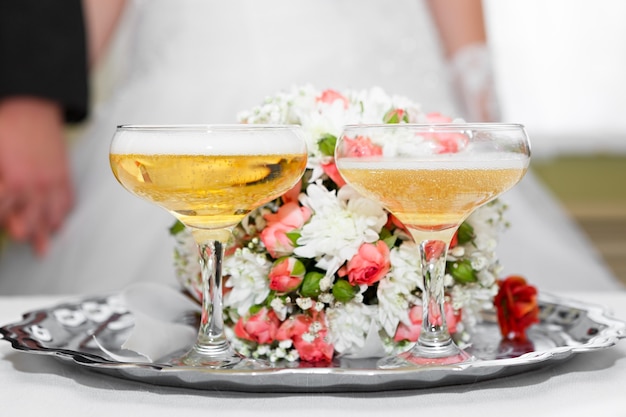 Wine glasses in hand bride and groom.