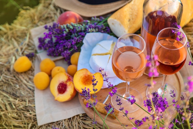 Wine in glasses. Picnic in the lavender field. Selective focus. Nature.