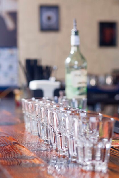 Wine glasses stand in a row on the bar