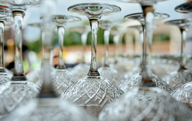 Wine glasses upside down on the table in nature . High quality photo