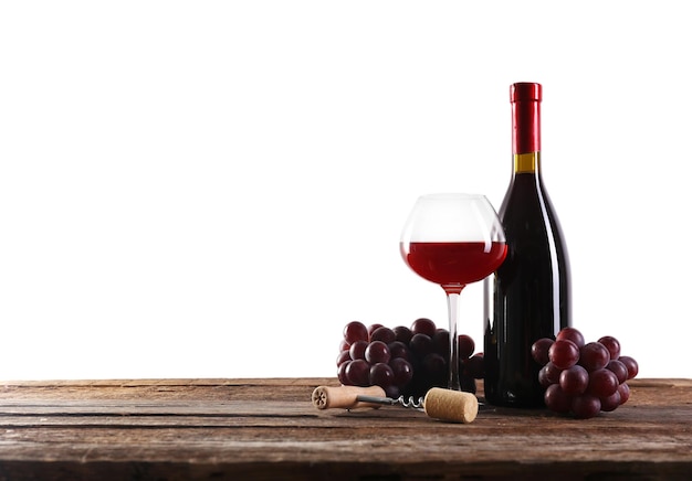 Wine and grape on wooden table against light background