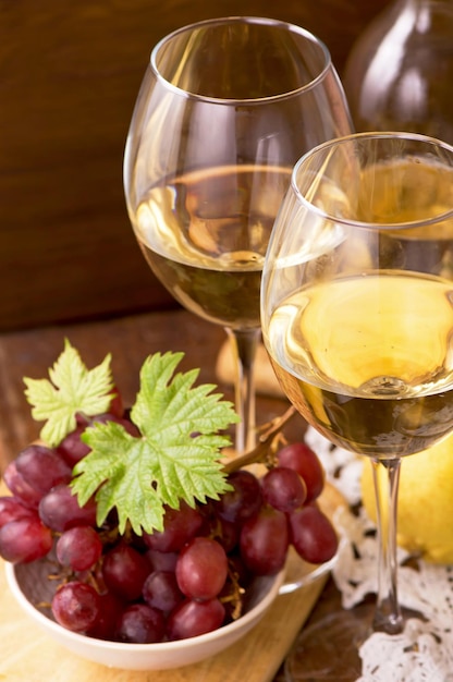 Wine and grapes in vintage setting on wooden table