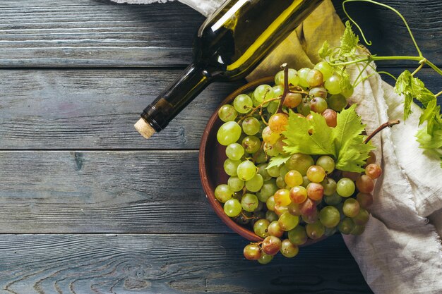 Wine and grapes on wooden background