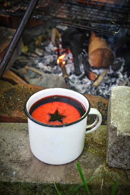 wine in an iron mug on near the fire