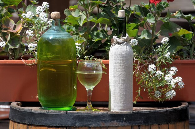 Wine in old bottles on a barrel.