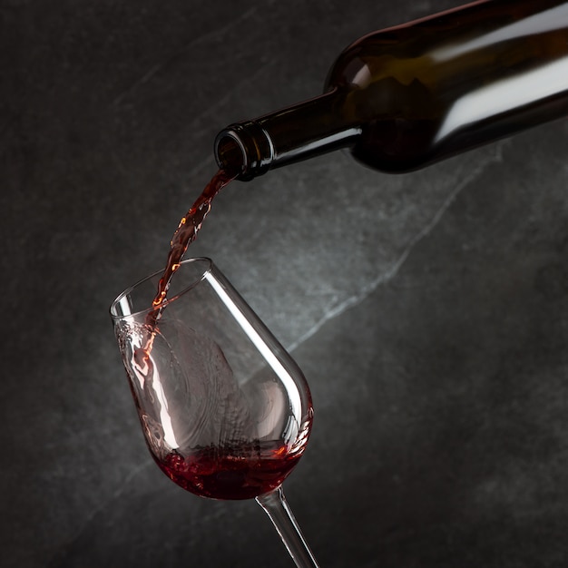 Wine pouring into glass from the bottle