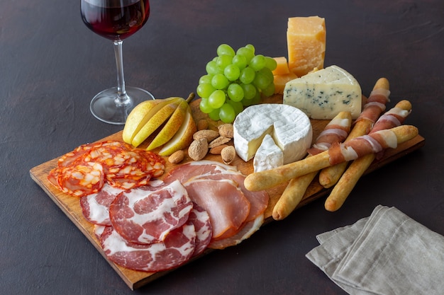 Wine snack. Jamon, camembert, chorizo, almonds, blue cheese, parmesan. Antipasti. Wine appetizer.