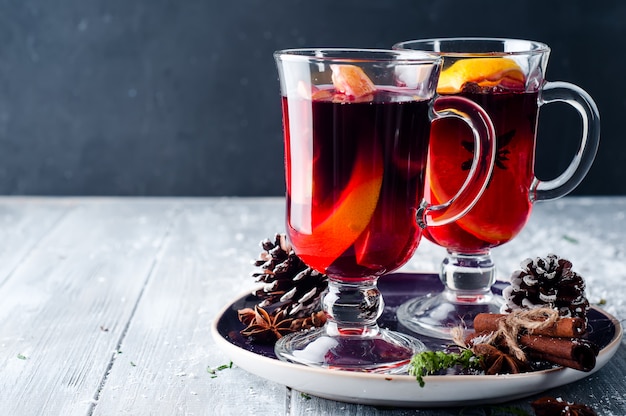 Wine and spices on wooden background.