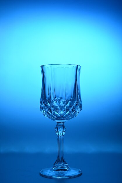 Photo wineglass. fine cristal glassware concept. vertical, toned in blue