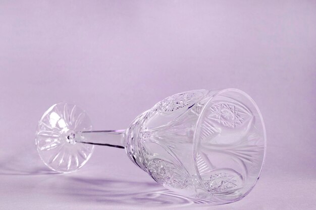 Wineglass lying on purple background