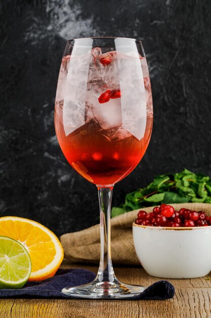 Wineglass with cranberry wine mint orange and lime