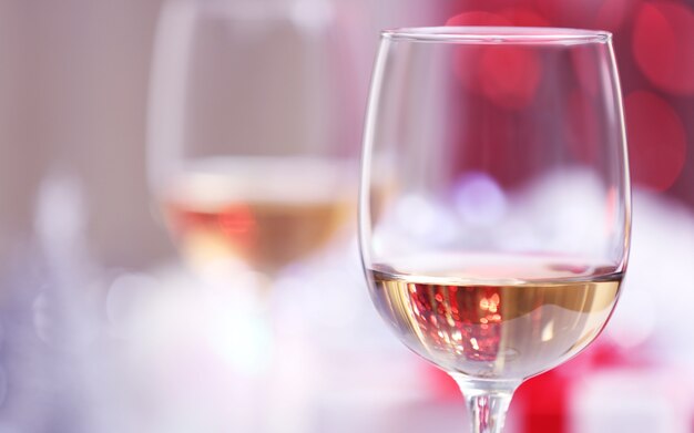 Wineglasses on blurred lights background