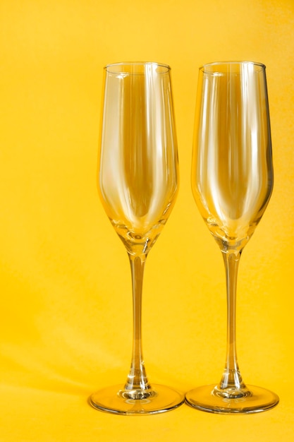 Wineglasses on yellow background