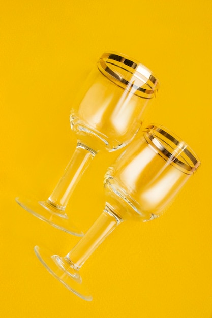 Wineglasses on yellow background