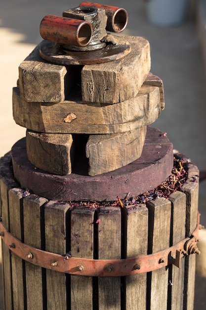 Winepress with red must and helical screw. Production of traditional Italian wines, crushing of grapes.