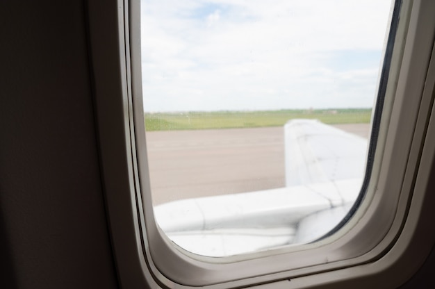 Wing of an aircraft in the aluminator window