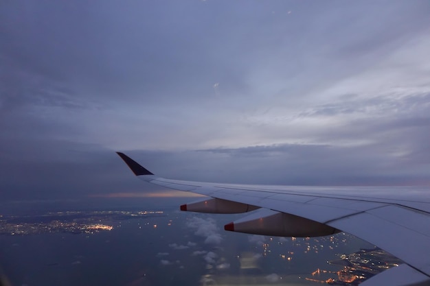 Wing of aircraft flying above the clouds