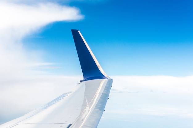 Wing of blue airplane in the air