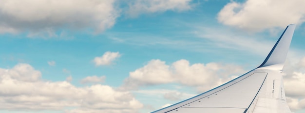 Wing of the plane on blue sky background