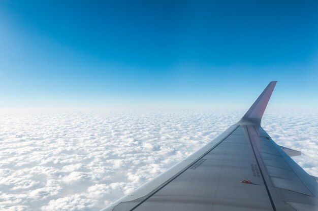 Wing of the plane above the clouds