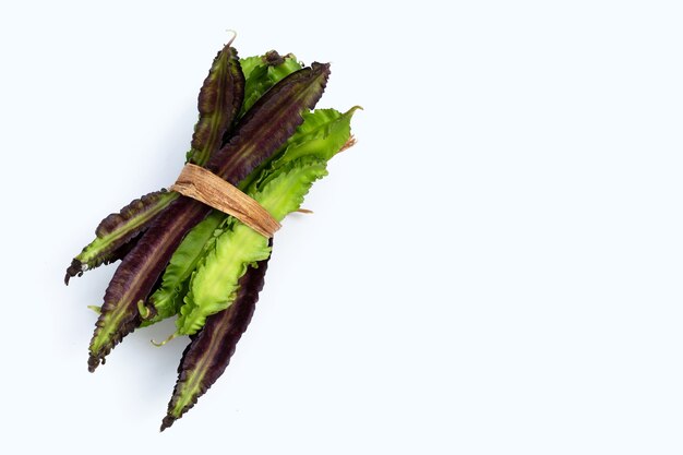 Winged bean on white surface