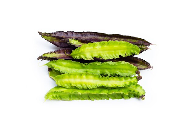 Winged bean on white surface